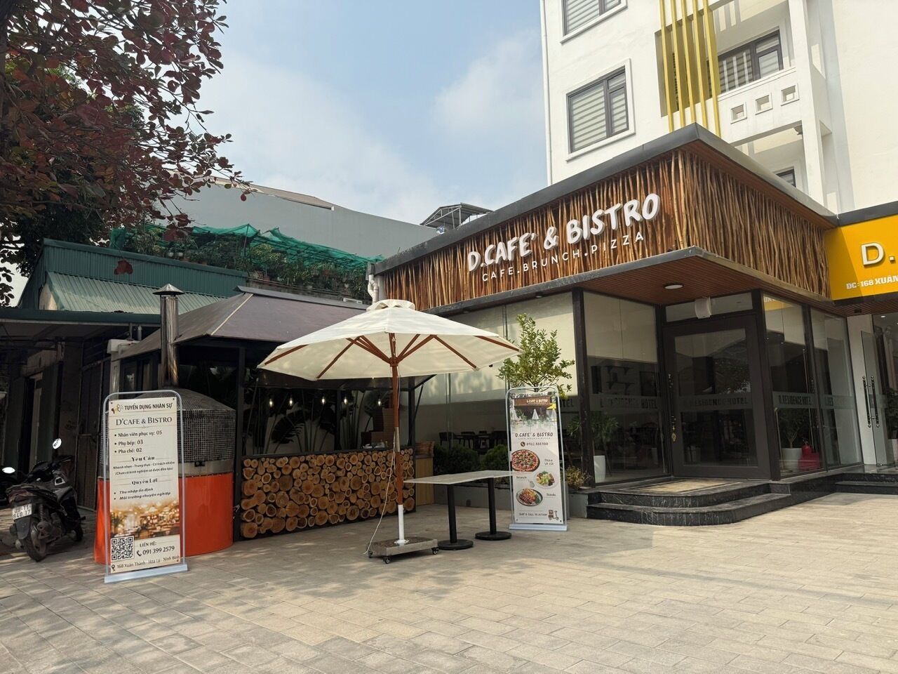 A D.Cafe & Bistro with outdoor seating and a modern facade.