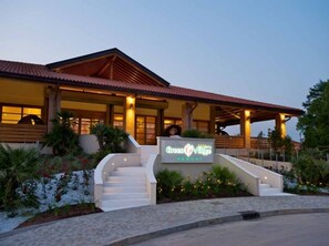 A resort building with a sign reading "Crescent Villas Resort."