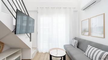 Standard Loft | Living area | 40-inch Smart TV with cable channels
