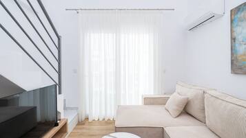 Standard Loft | Living area | 40-inch Smart TV with cable channels