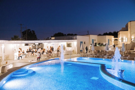 Outdoor pool, open noon to 7:00 PM, pool umbrellas, sun loungers