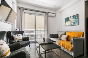 Apartment, 2 Bedrooms, Balcony, City View | Living room | 38-inch Smart TV with cable channels, streaming services