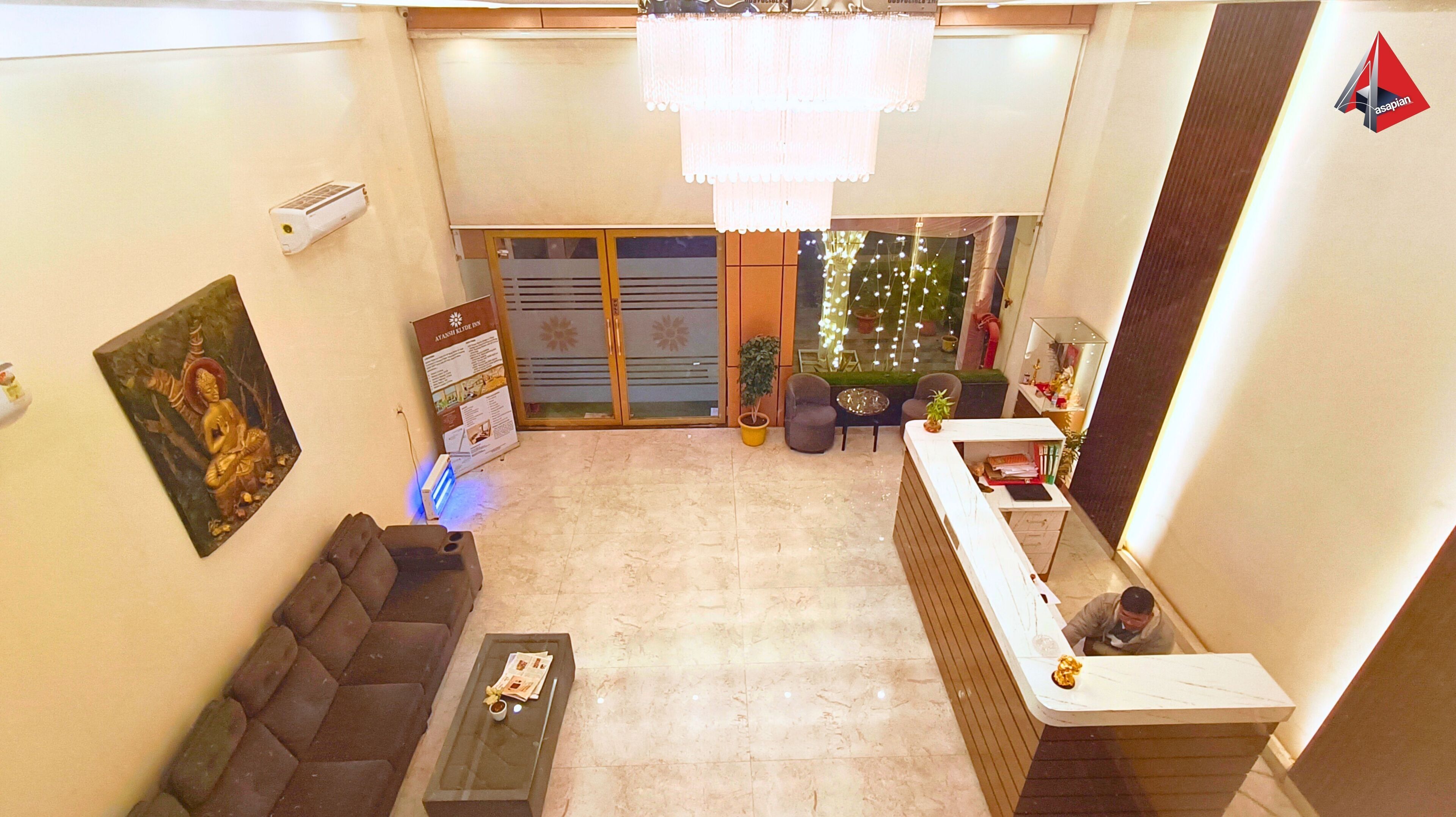 A spacious living area with a sofa, a coffee table, and a reception desk.