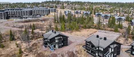A residential area with multiple houses and a large building complex.