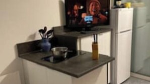 A compact kitchen with a small island, a refrigerator, and a microwave. - Studio 1 to 4 persons (Bandol)