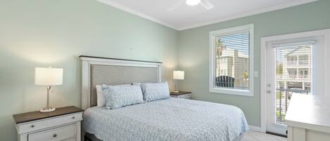 A bedroom with a bed, nightstands, a ceiling fan, and a window with blinds.