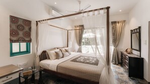 A four-poster bed with a canopy, a bedside table, a mirror, and a view of the outdoors. - Amã Stays & Trails Assa 360, Goa (Anjuna)