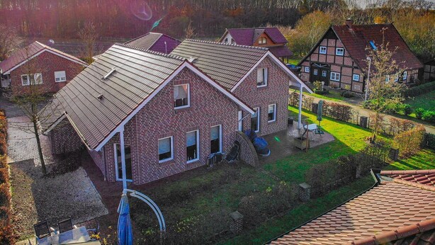 A residential area with houses featuring red brick exteriors and pitched roofs. - Beautiful vacation home "Nele"! Perfect for the family (Geeste)
