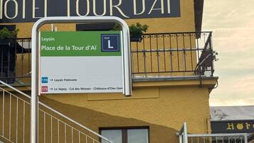 A sign for Hotel Tour d'Ai with directions to nearby locations.