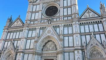 A large, ornate building with a prominent central dome, detailed facade, and a large entrance.