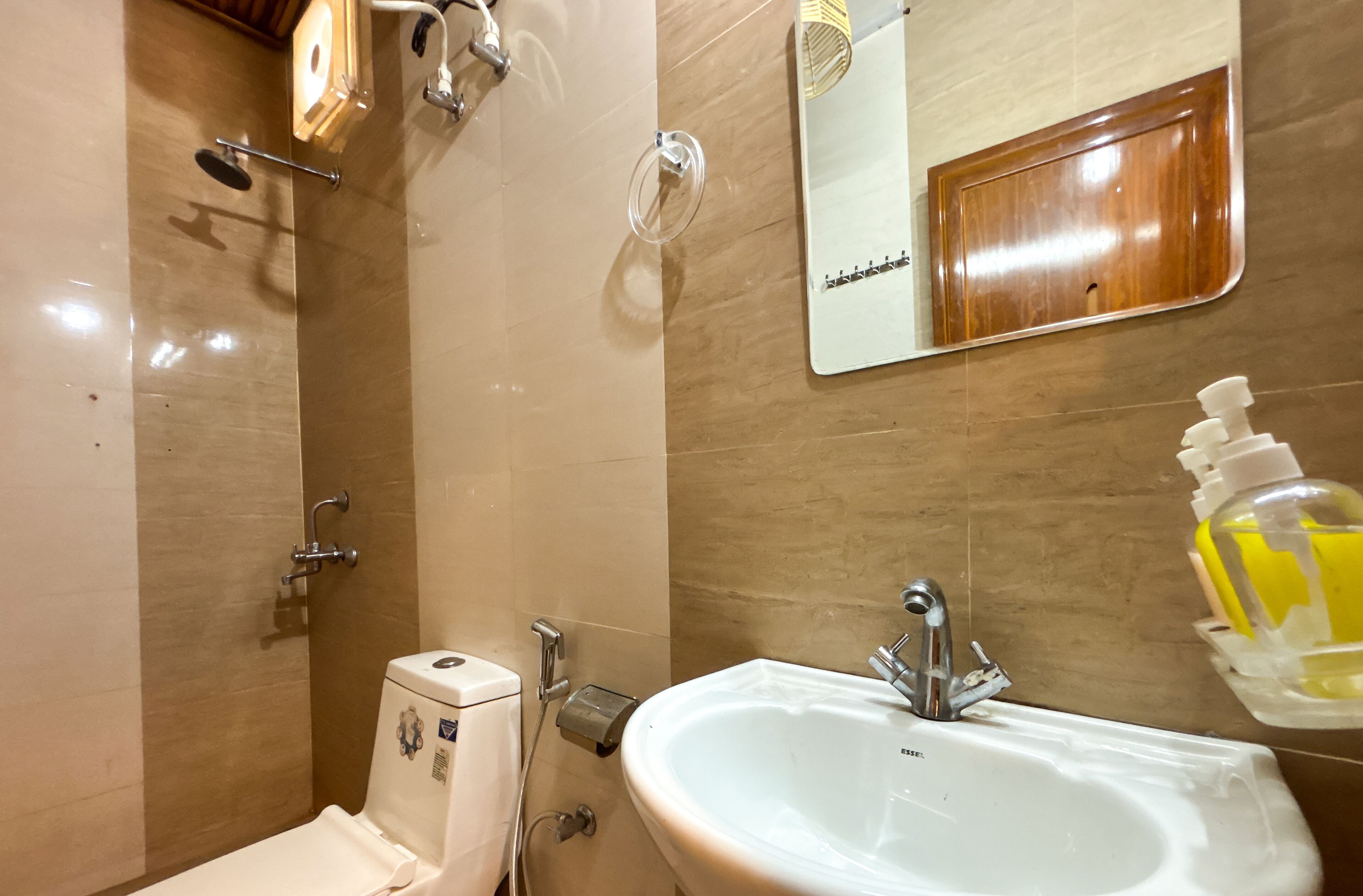 Een badkamer met een wit wastafelmeubel, een spiegel en een douche.