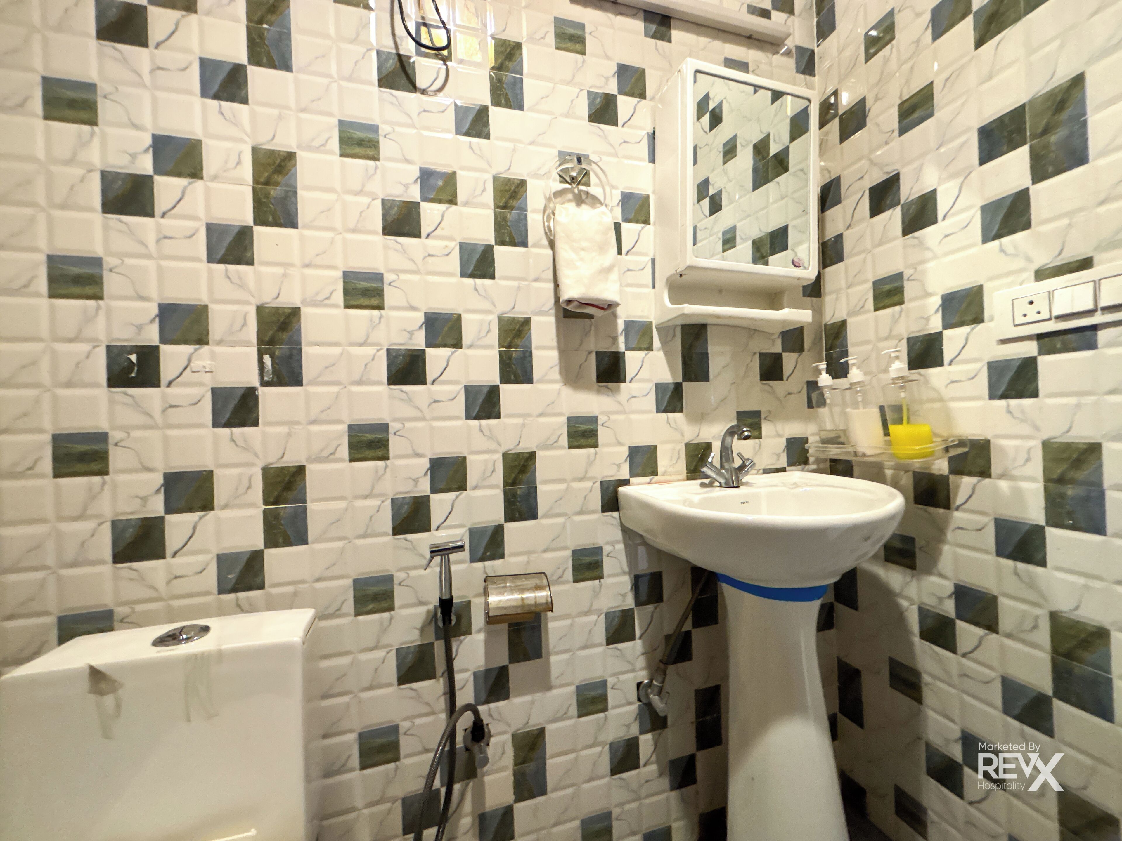 A bathroom with a white sink, a mirror, and a shower.