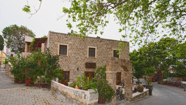 A stone building with a sign reading "SITIO". - Arionos Rooms (Rhodes)