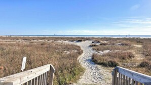 A sandy beach path leading to the ocean with a wooden fence on one side. - Holiday Isle SandDollar 713 (Dauphin Island)