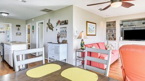 A compact living space with a dining area, kitchenette, and seating area. - Walk to Beach: Galveston Home w/ Patio & Balcony! (Galveston)