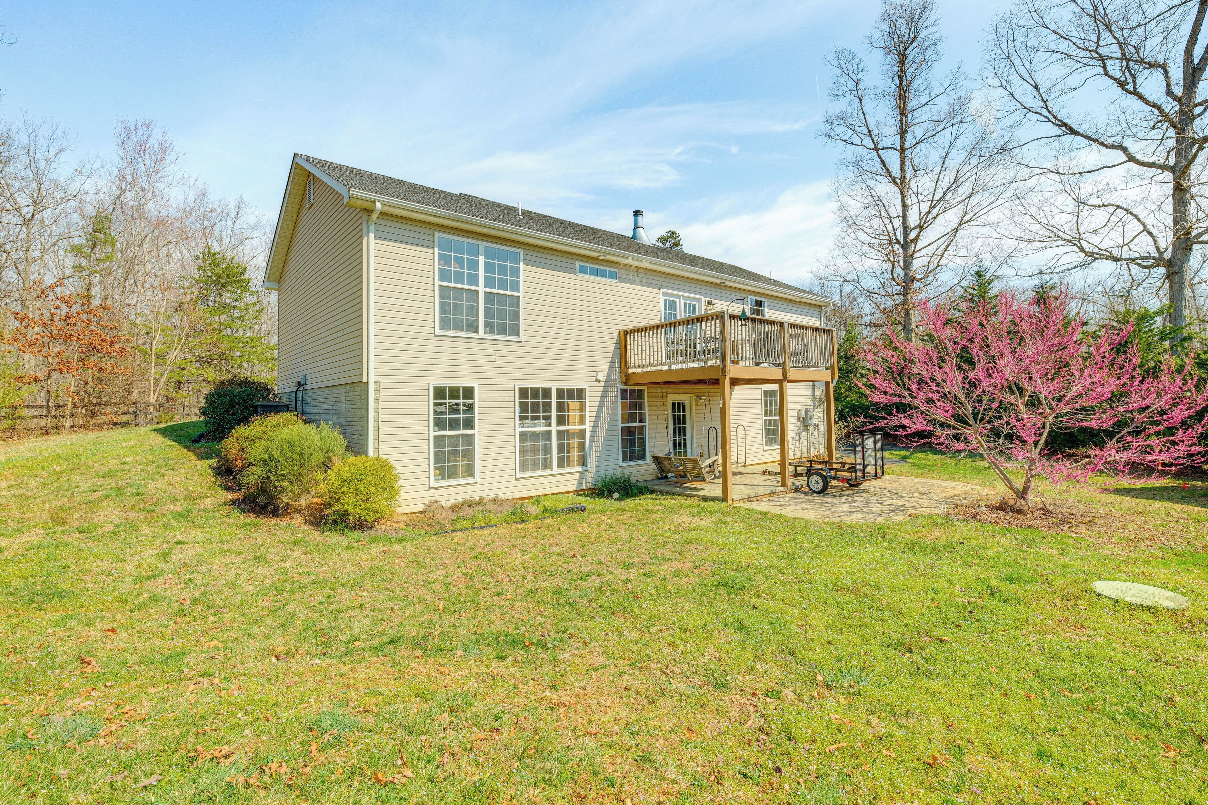 A two-story house with a front porch and a small deck.