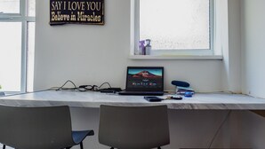 A workspace with a desk, two chairs, a laptop, and a motivational quote on the wall. - WoodHus Lodge  Cosy Large Family  Room 4 (Stoke-on-Trent)