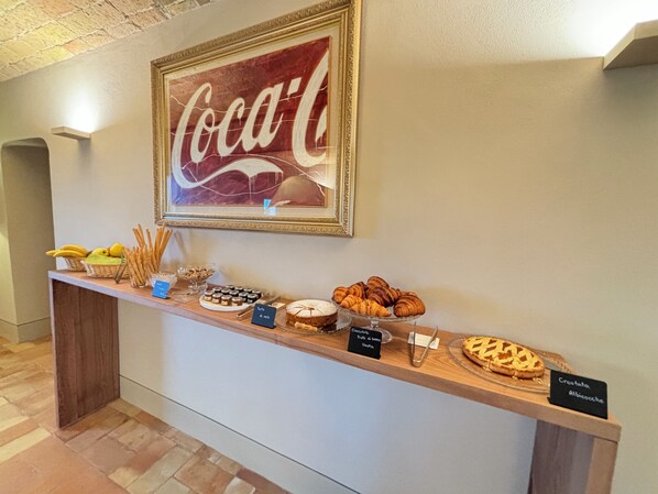 A buffet counter with various food items and a Coca-Cola sign above it. - Relais Dal Cavaliere (Moncalvo)
