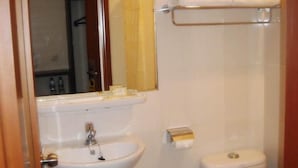 A small bathroom with a sink, toilet, and mirror. - Losari Roxy Hotel Jakarta (Jakarta)