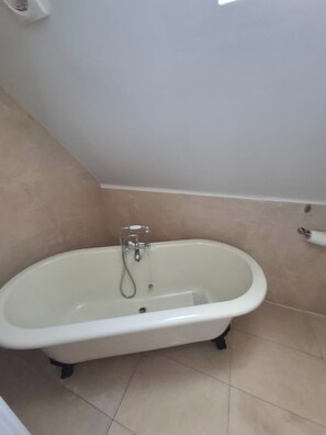 Separate bathtub and shower, deep-soaking bathtub, hair dryer, towels