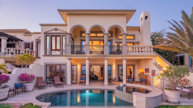 A luxurious two-story house with a swimming pool, outdoor seating, and a well-maintained garden. - Luxury Cabo Del Sol Oceanfront Villa w/ Infinity Pool, Walk to Beach & Golf View (Corridor)