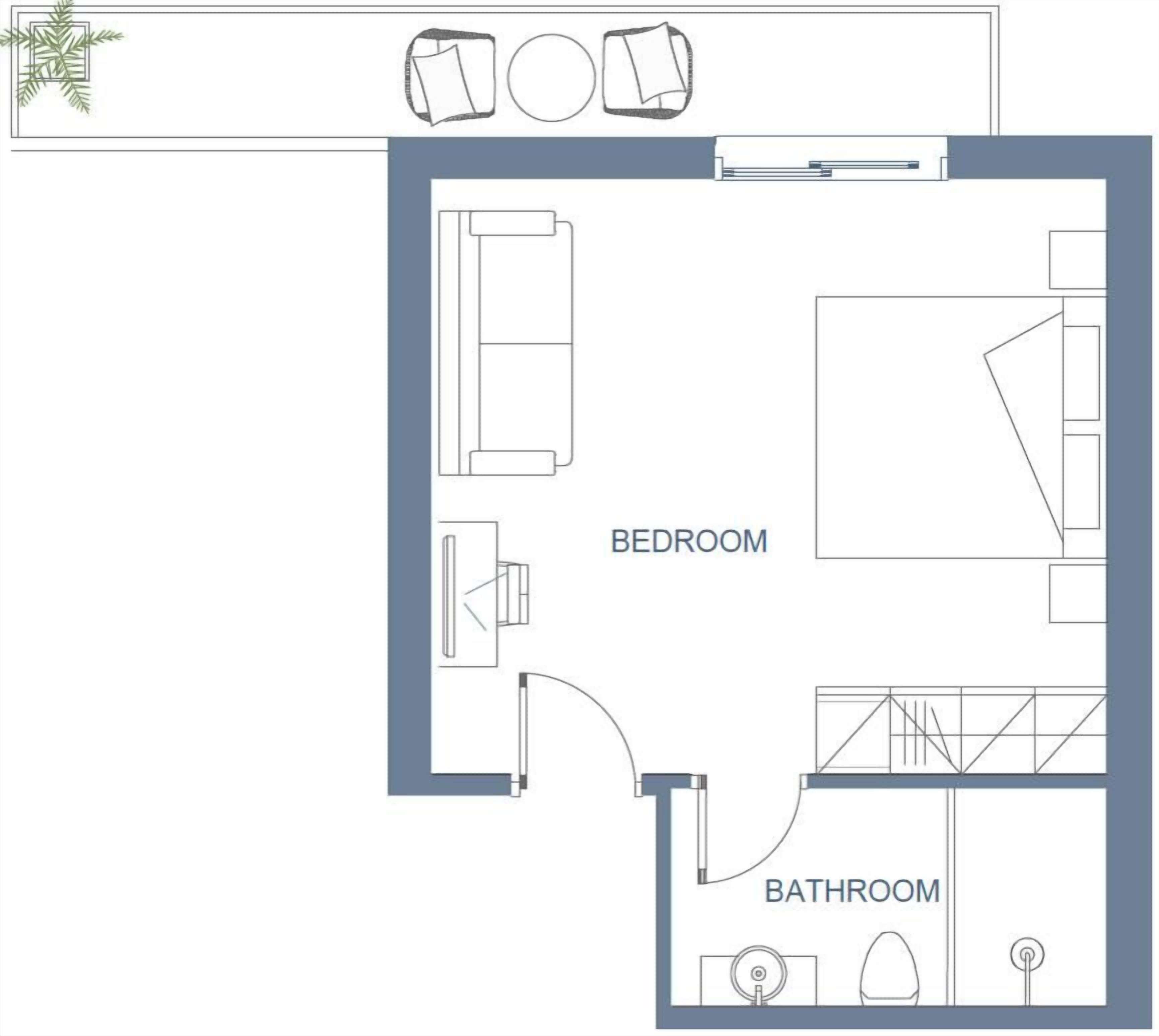 Plano de planta que muestra un dormitorio, baño y una pequeña zona de estar.
