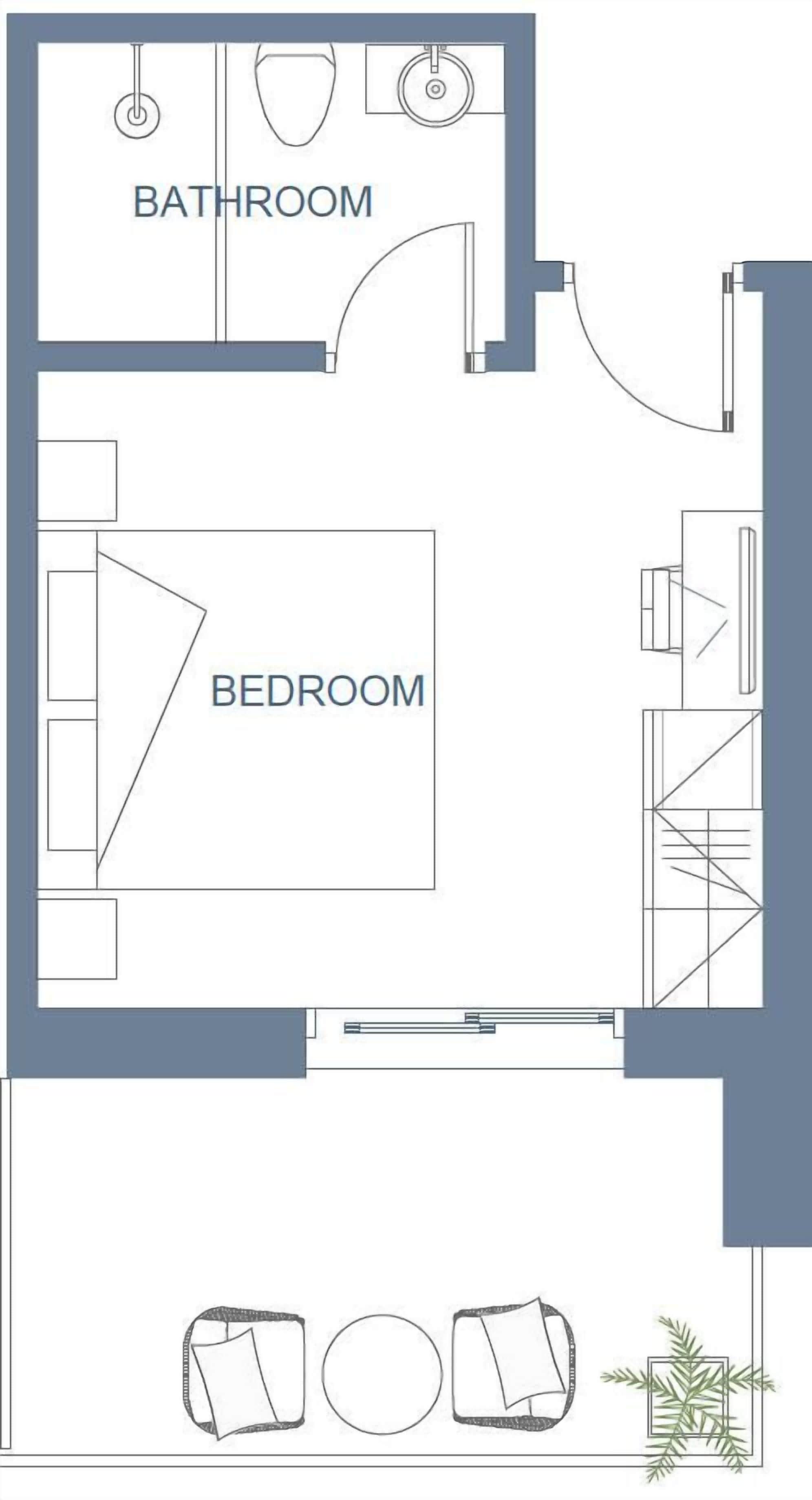 Plano de planta que muestra un baño y un dormitorio, con una cama y un escritorio.