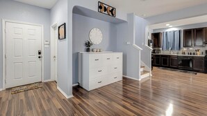 A modern kitchen with dark cabinets, a white countertop, and a built-in oven.