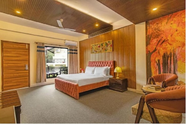 A bedroom with a large bed, a wooden ceiling, a painting, and a view of the outside. - Maple Resort Chail (Chail)
