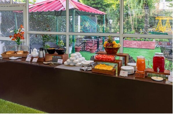 A breakfast buffet with various food items and a coffee station. - Maple Resort Chail (Chail)