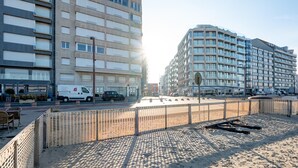 Ein modernes Gebäude mit mehreren Stockwerken, großen Fenstern und einem Flachdach.