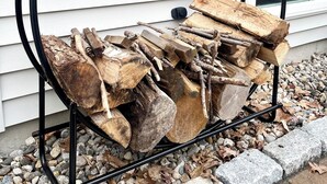 A black metal firewood rack outside a house with siding and a window. - Family friendly and dog welcoming home, minutes from the beach in Old Orchard! (Old Orchard Beach)