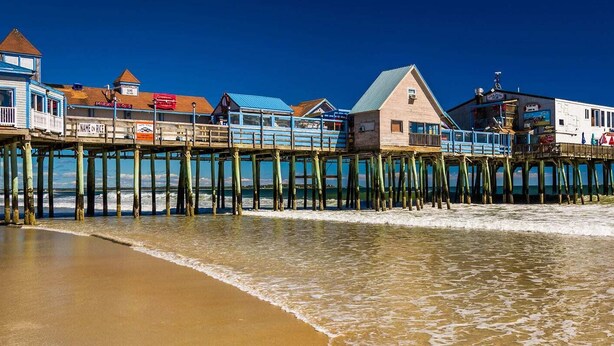 A pier with buildings extending over the water, including a restaurant and a bar. - Family friendly and dog welcoming home, minutes from the beach in Old Orchard! (Old Orchard Beach)