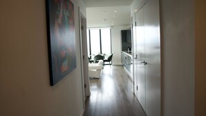Un couloir menant à une salle à manger avec vue sur l’extérieur.