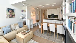 A modern apartment with a living room, dining area, kitchen, and a balcony. - Duplex at Albert Beach With Stunning Sea Views (Knokke-Heist)
