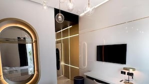 Ein modernes Schlafzimmer mit einem großen Bett, einem Schreibtisch und einem Fernseher.