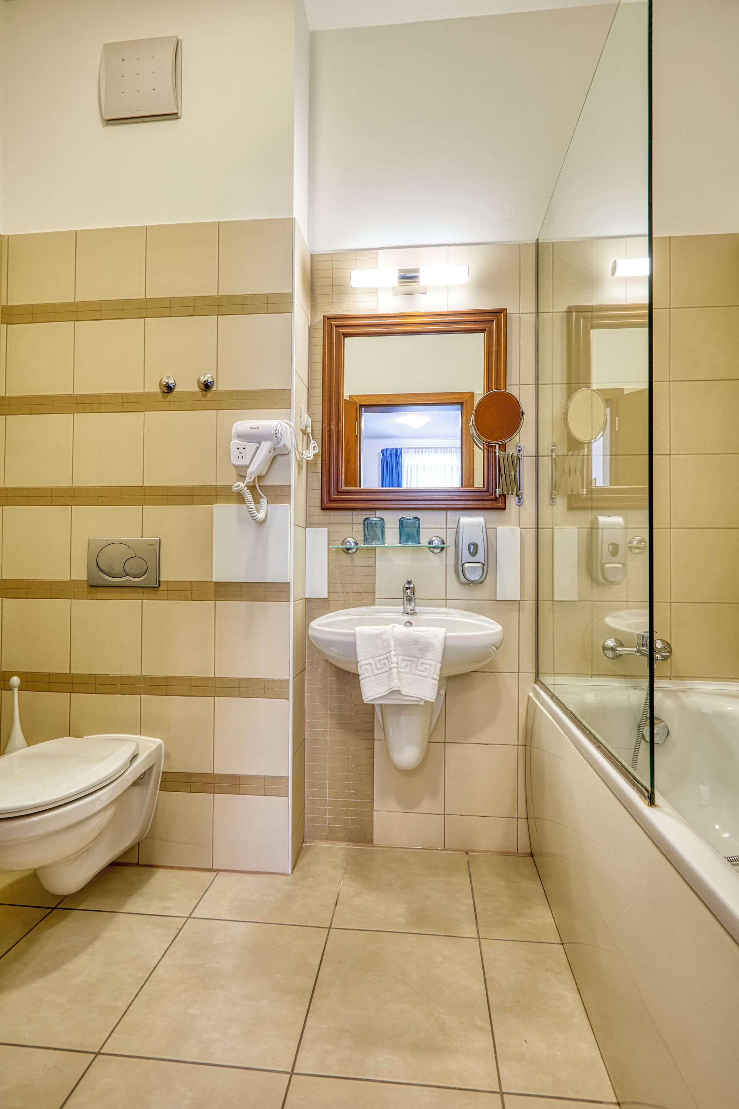 A bathroom with a toilet, sink, and bathtub.