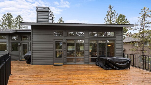A modern house with a deck, large windows, and a chimney. - TITL08 - Fantastic Sunriver Home, Hot Tub (Sunriver)