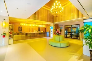 A modern lobby with a reception desk, a central seating area, and a staircase leading to upper floors. - Jinjiang Hotel (Beijing Shunyi Li Xiang Auto Base) (Beijing)