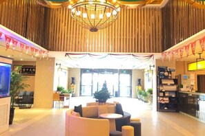 A hotel lobby with a chandelier, seating area, and a reception desk. - Jinjiang Hotel (Beijing Shunyi Li Xiang Auto Base) (Beijing)