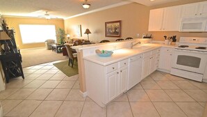 A modern kitchen with white cabinets, a large island, and a built-in oven. - Boat Slip - Pool- Screened balcony- Water front. 30 DAY MINIMUM STAY. (Gulf Shores)