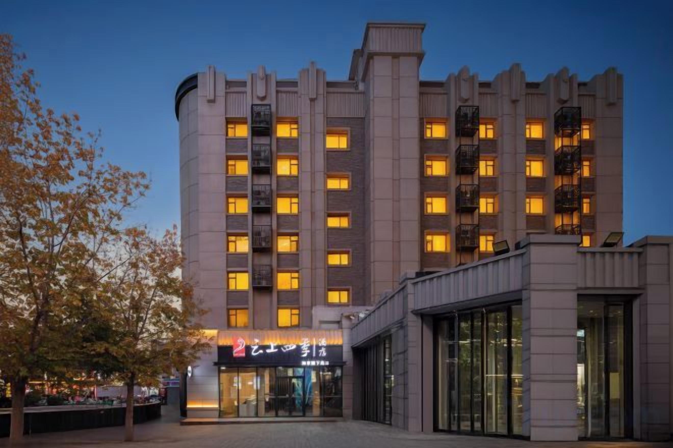 A multi-story hotel with a modern facade, large windows, and a prominent entrance.
