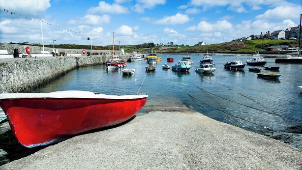 A harbor with boats docked at the pier. - Cornel Clud (Cemaes Bay)