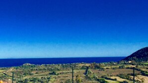 A coastal landscape with a clear view of the sea and a hilly terrain in the background. - APARTMENT WITH SEA VIEW TERRACE (Tanaunella)