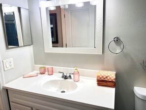 A bathroom with a white sink, a mirror, and a towel rack. - Comfort Cove, 3BR, 2BA, Fully Fenced, Spring Hill, FL (Spring Hill)