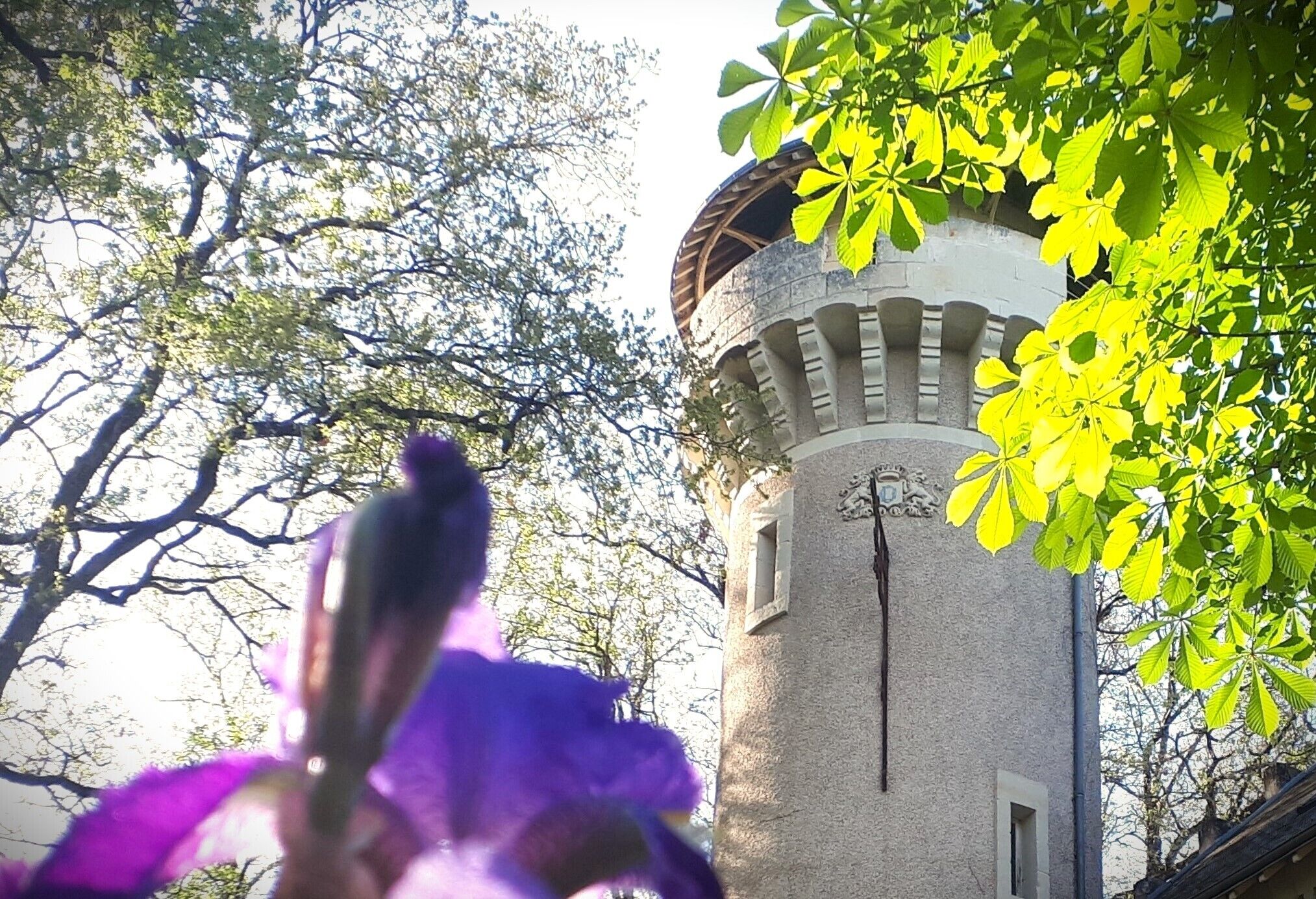 A tower with a stone exterior and a window with a sign.