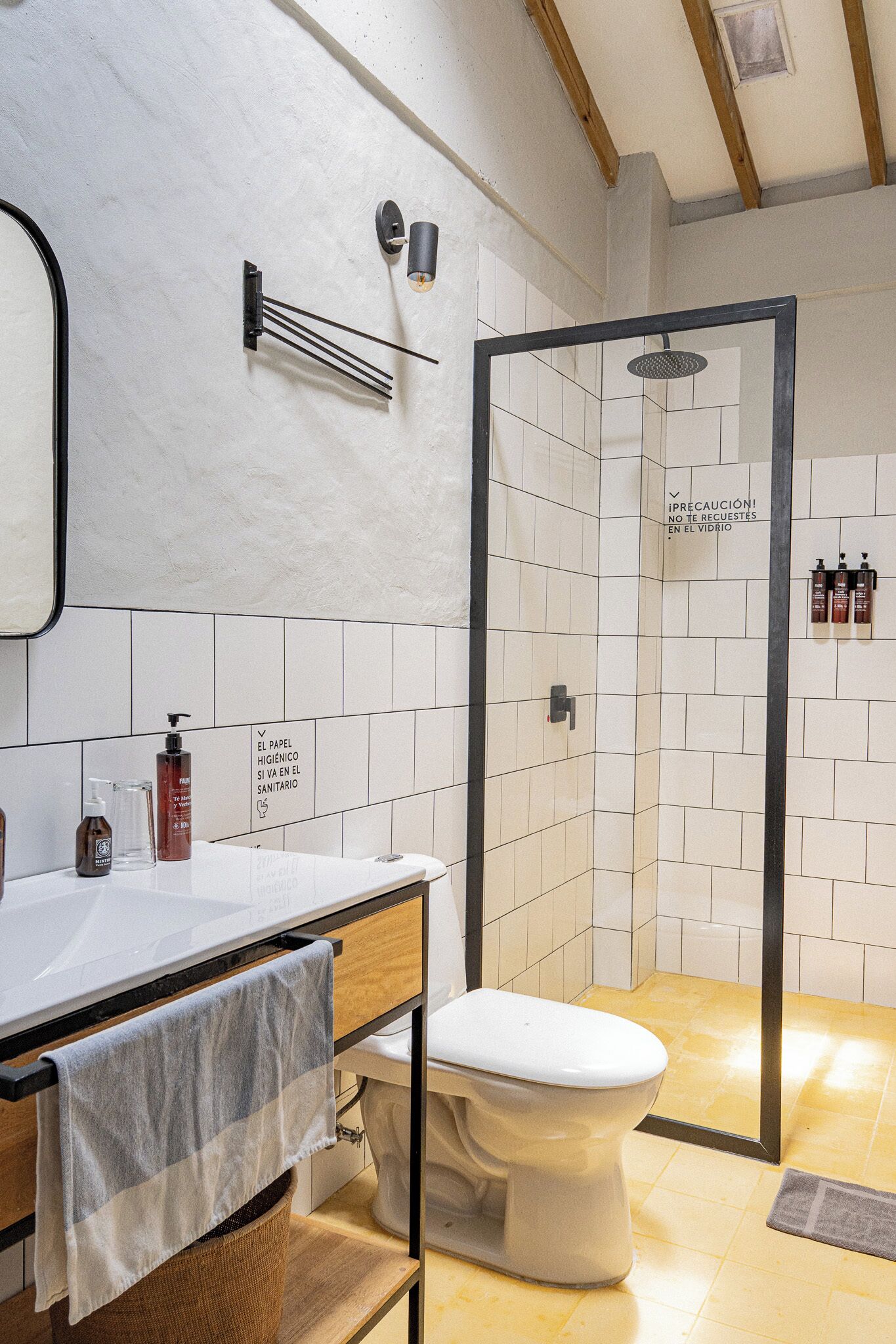 A bathroom with a white sink, a toilet, and a shower area.