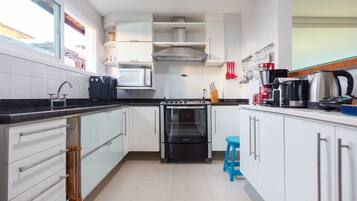 Villa | Private kitchen | Fridge, microwave, electric kettle, cookware/dishes/utensils