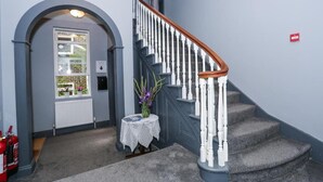 A staircase with white balusters and a wooden handrail, leading to an upper floor. - Beckenham Park Hotel (Beckenham)