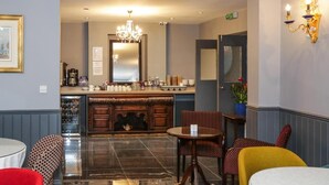 A hotel lobby with a bar area, a chandelier, and a seating area with chairs and tables. - Beckenham Park Hotel (Beckenham)